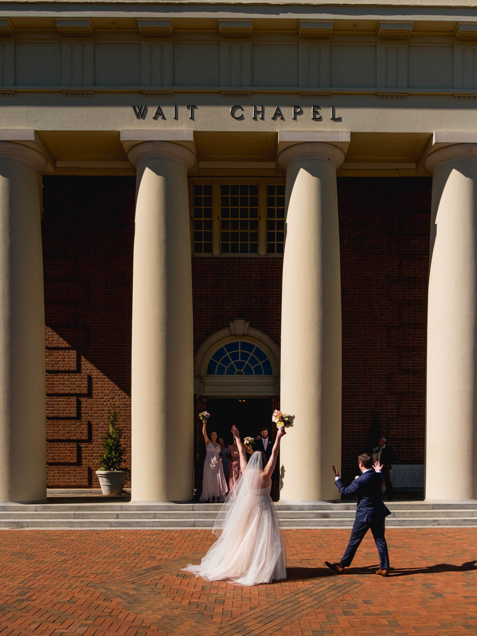 bride and groom welcome their wedding party after the recessional at Wait Chapel
