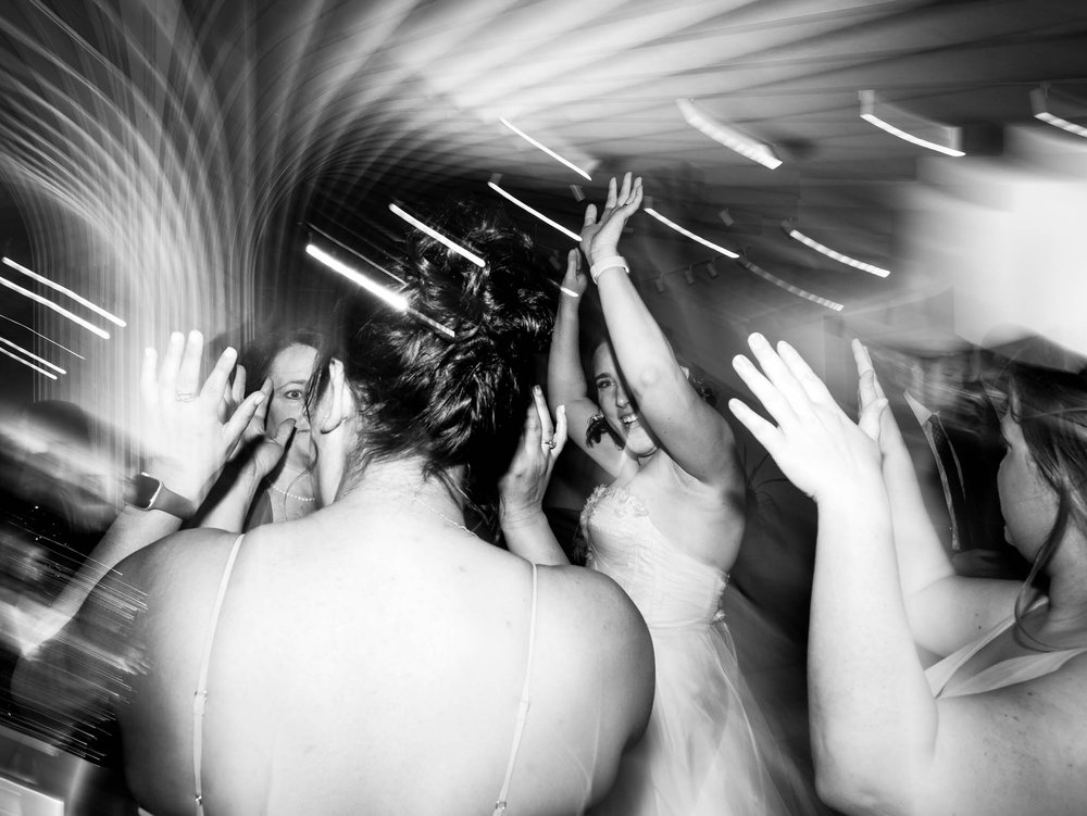 bride dancing with friends during the reception at Milton Rhodes Center for the Arts