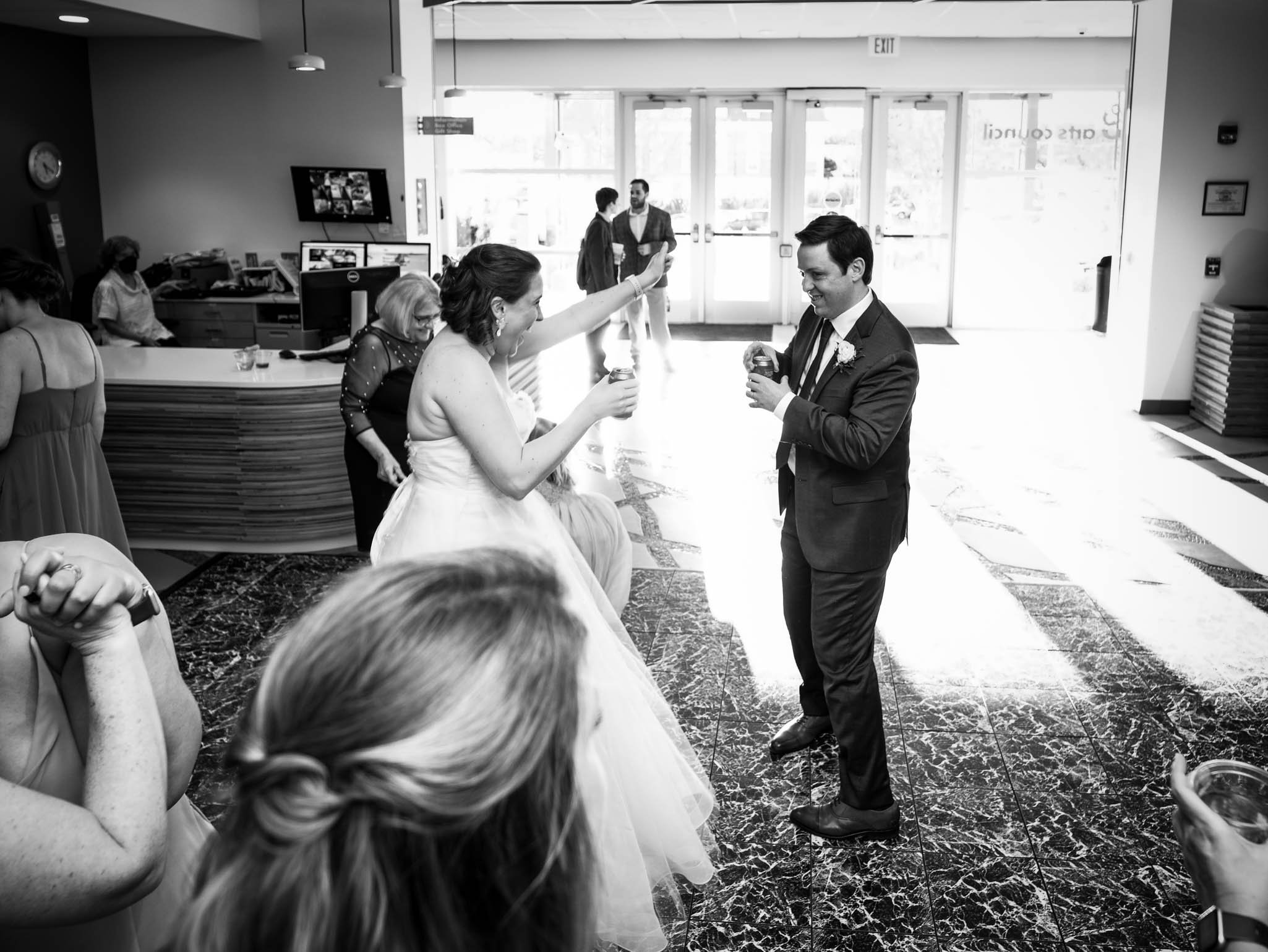 bride and groom jump on the dancefloor at their wedding reception
