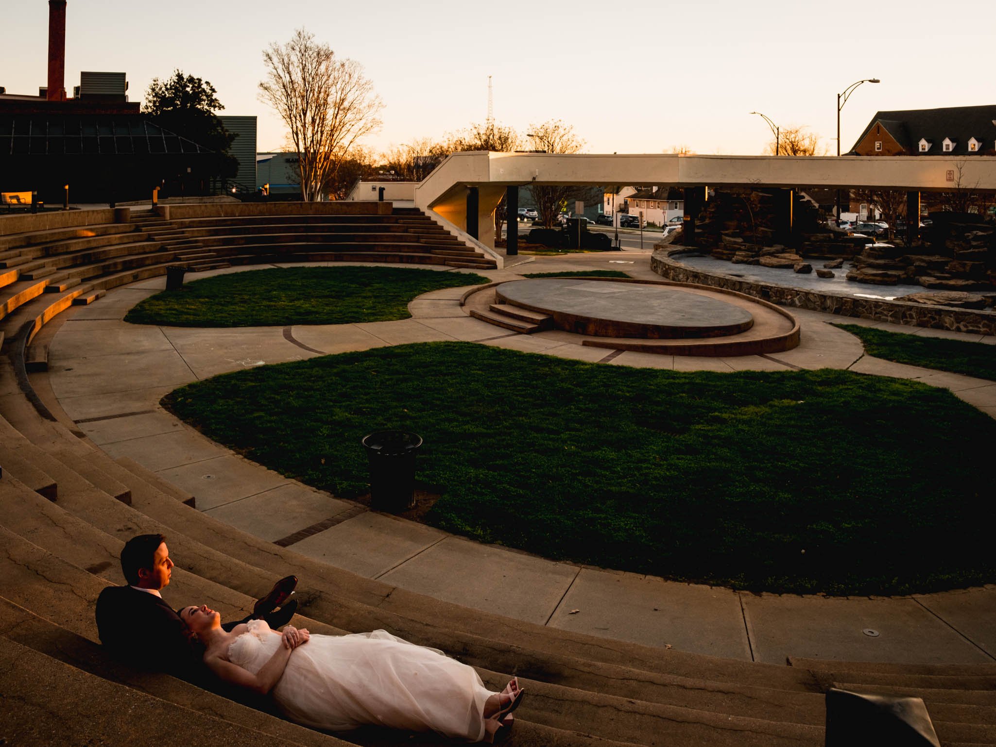 bride and groom look out at the sunset during their reception at Milton Rhodes Center for the Arts