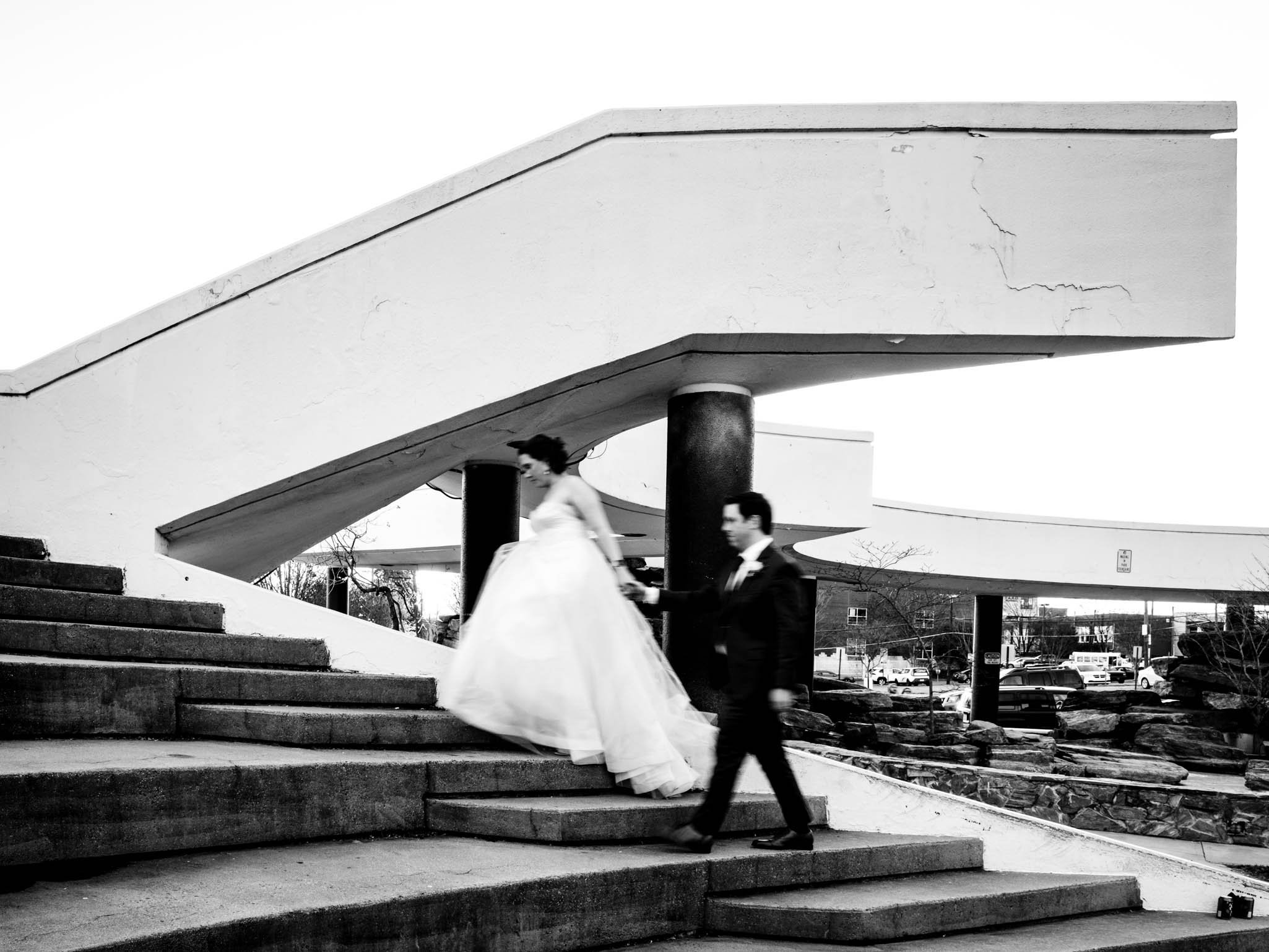 bride and groom walk up the step at Winston-Salem park