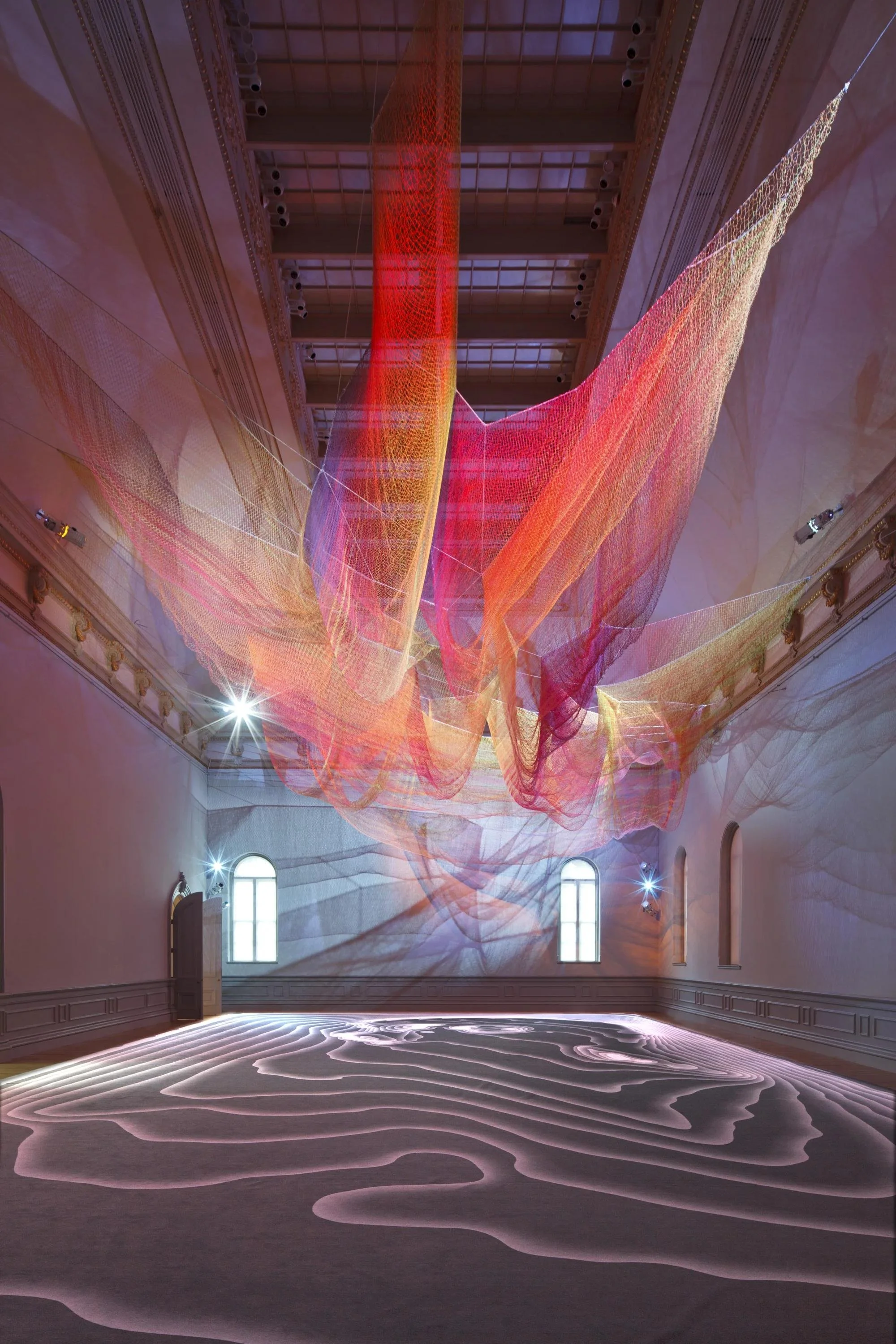 Janet Echelman’s 1.8, a vast suspended sculpture of interconnected fibres forming a flowing, colourful net overhead.