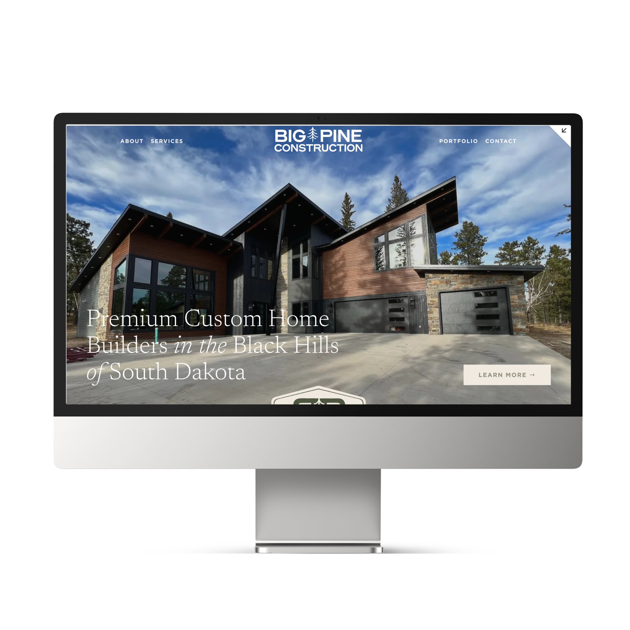 Website homepage for Big Pine Construction, a custom home builder in South Dakota, featuring a modern house with large windows and forest background.