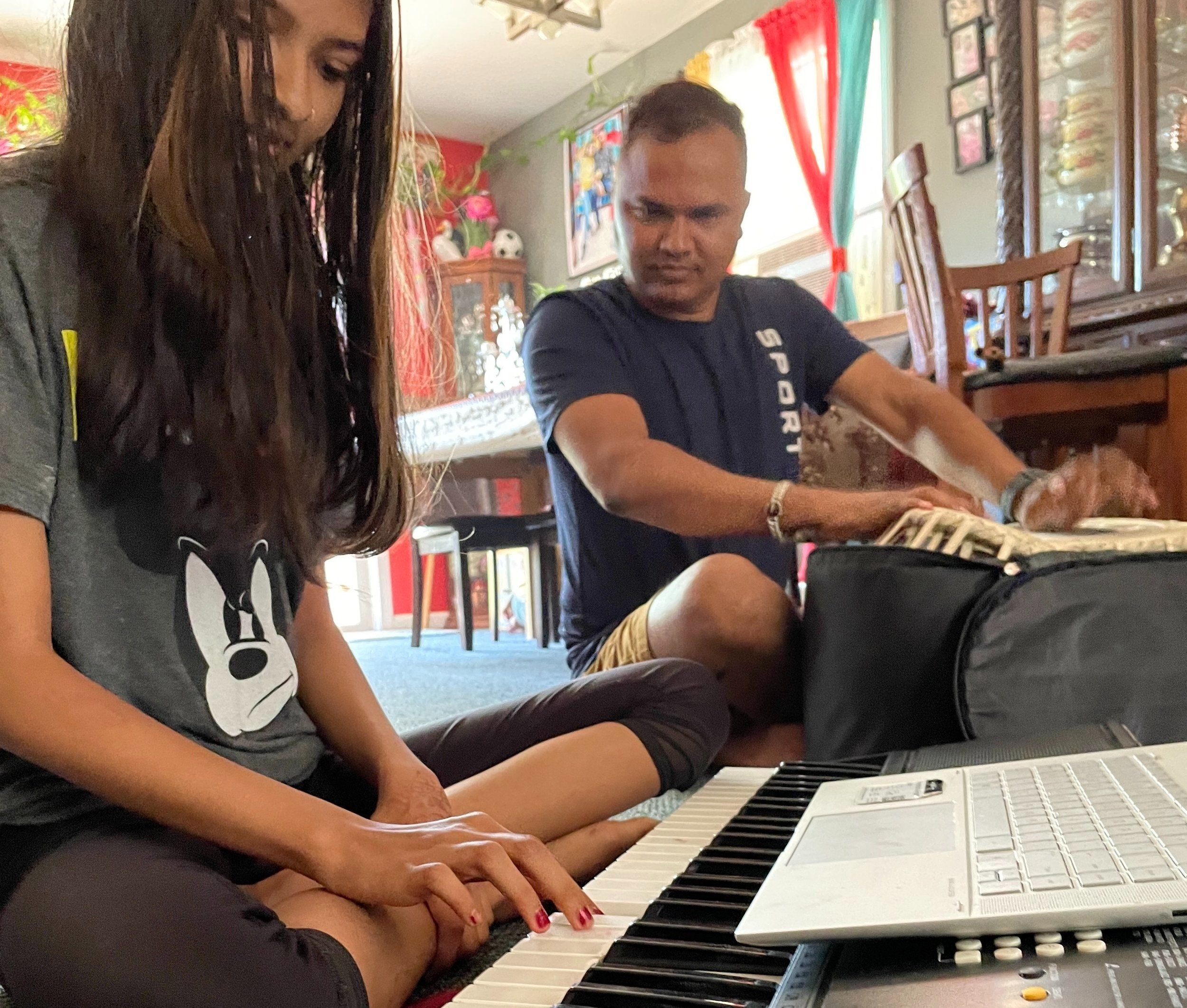 Isika Niroula and her father Gopal Niroula play a Nepali song.