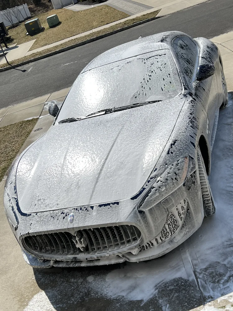 Maserati covered in foam during a hand wash