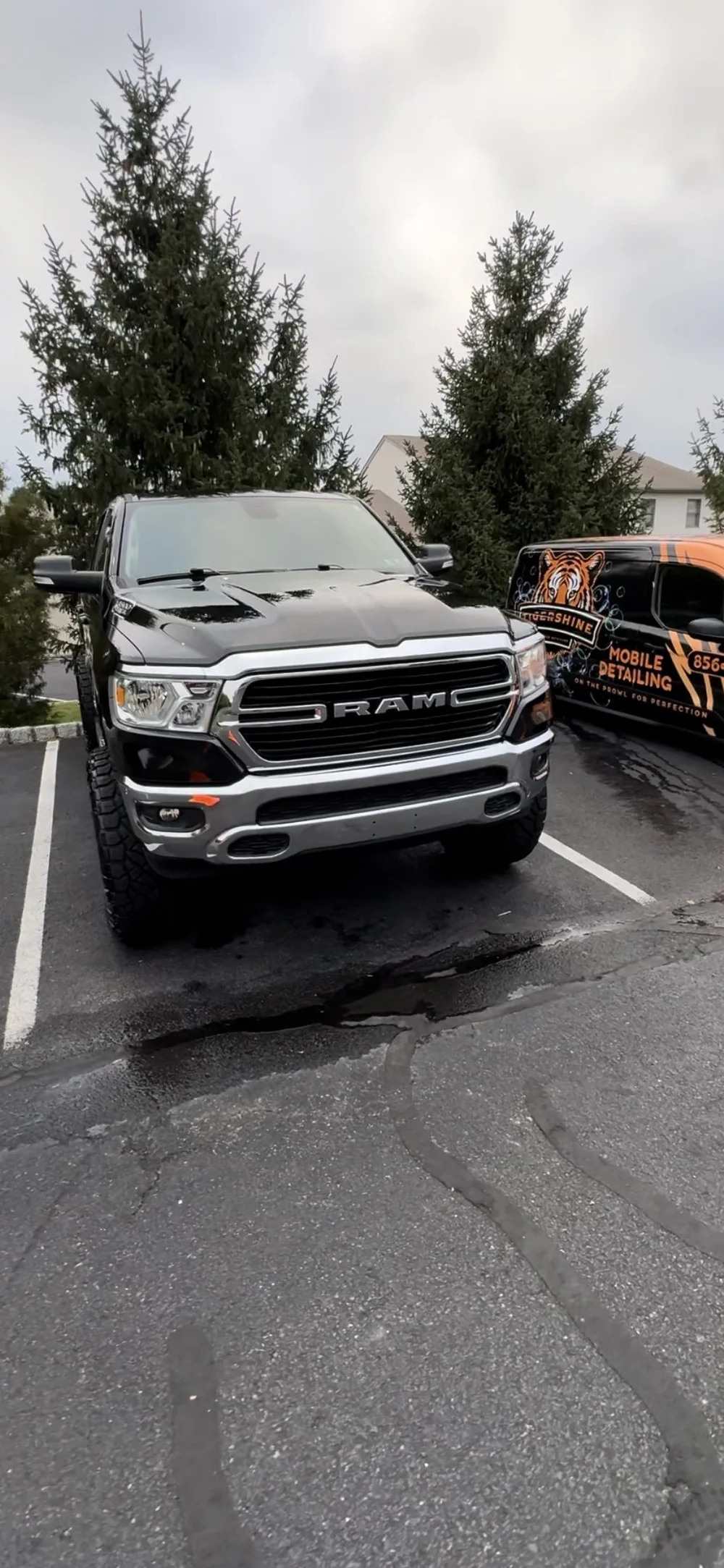 Gray Ram pickup truck with the Tigershine van behind it