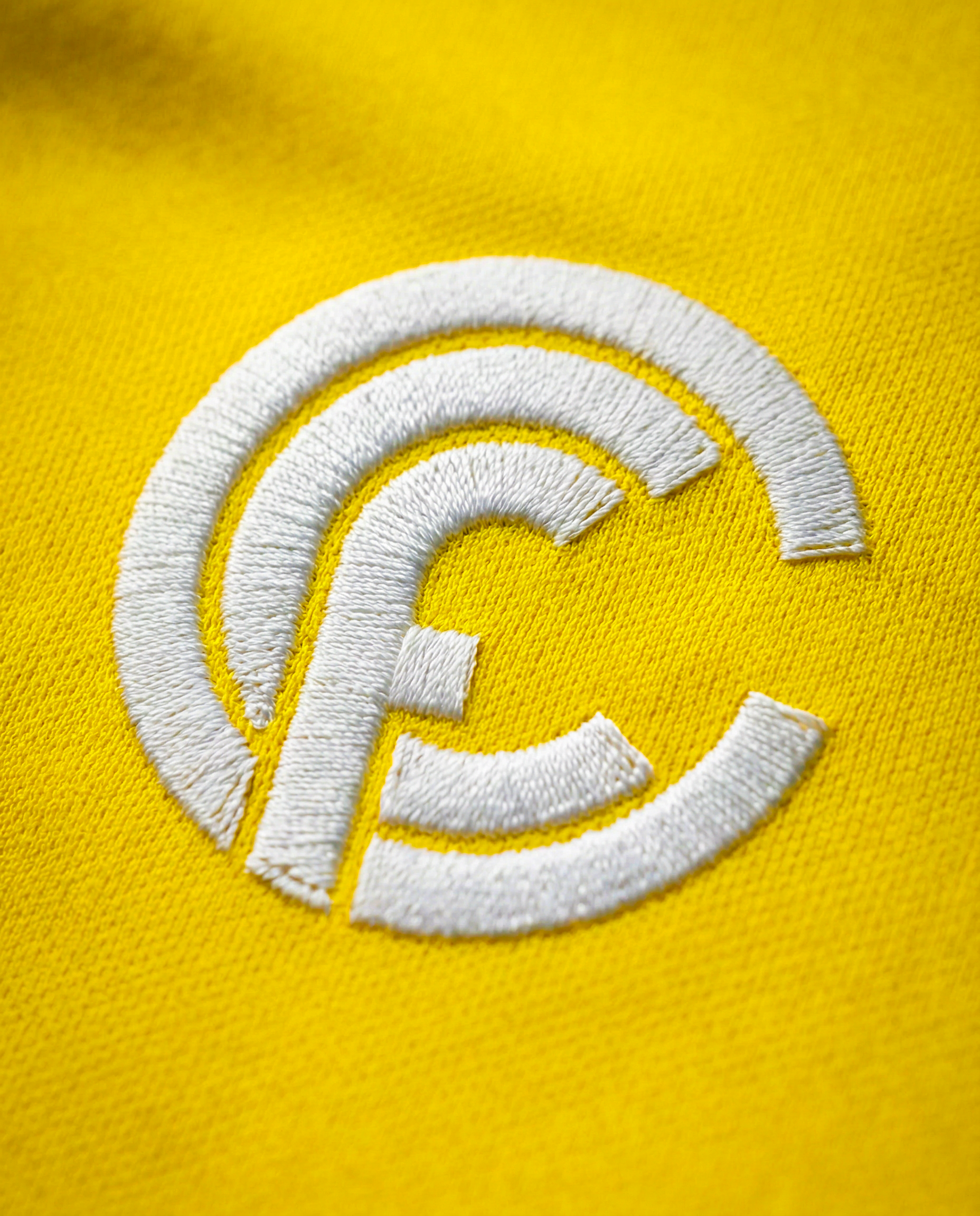 freepik_ultra-closeup-macro-shot-of-a-premium-football-jersey-fabric-in-vibrant-yellow.-the-fabric-shows-detailed-texture-woven-polyester.-the-fabric-should-represent-the-img1-jersey.-at-the-cent_0001 (2).png