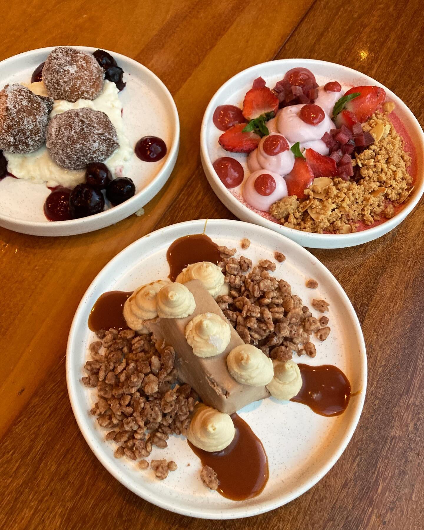 Edible works of art! These desserts @charcut are as tasty as they are pretty. Starting at the top and working clockwise - Portuguese Doughnuts with kirsch macerated cherries, Charcut Cheesecake with poached rhubarb and Salted Caramel Crunch with carm