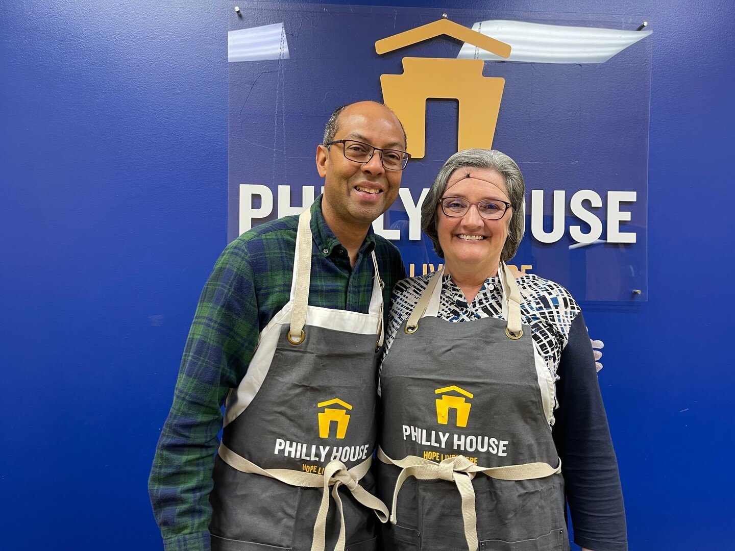 It&rsquo;s all smiles in the Philly House kitchen as our volunteers celebrate our new aprons! Albert and Judy, pictured above, have been volunteering at Philly House for over 10 years. We are thankful for their continued support!

You can learn more 