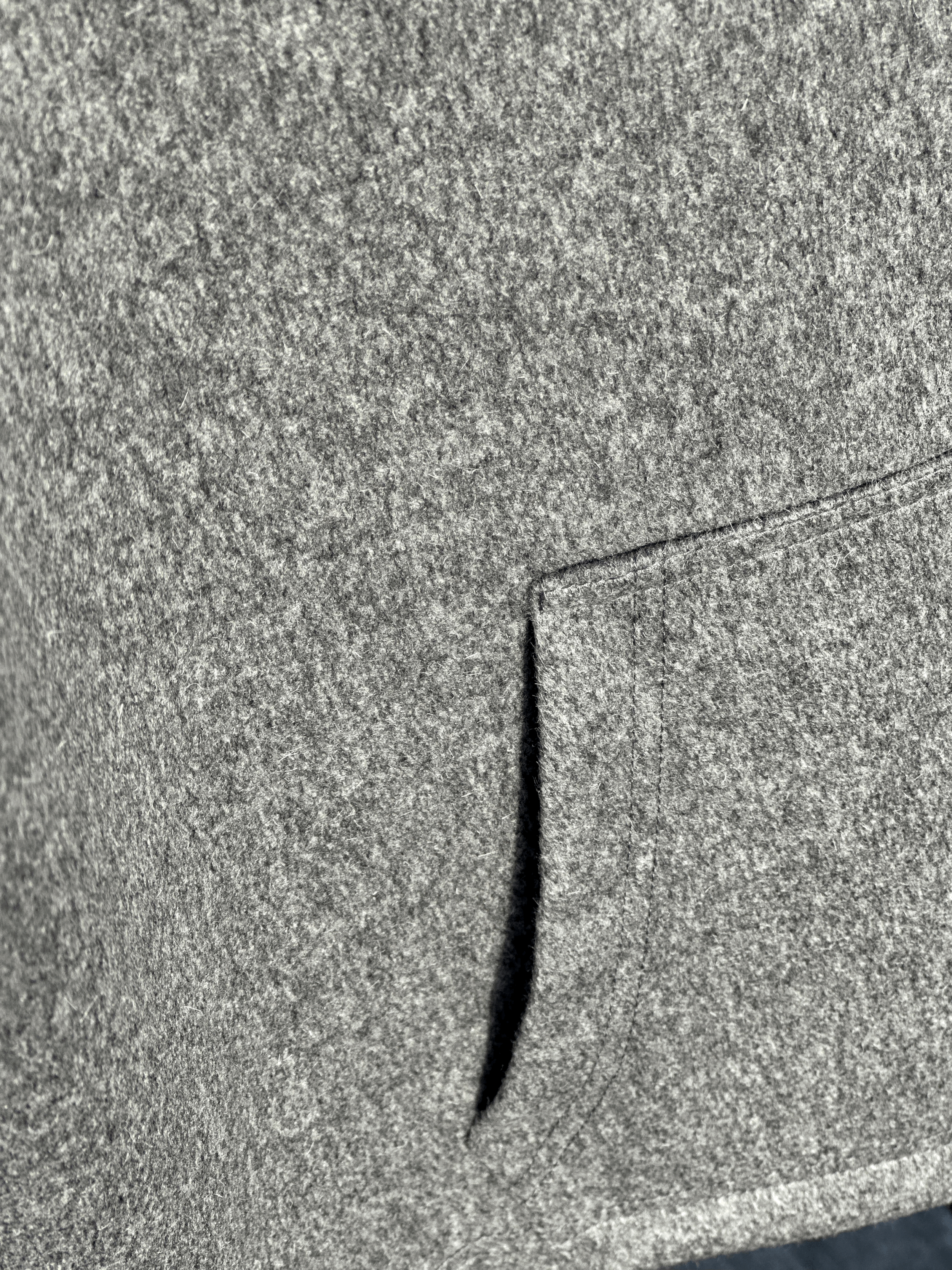 Close-up of the Granite Island Silvery Grey Angora Hoodie, highlighting its textured grey fabric and the stitching around the front pocket.