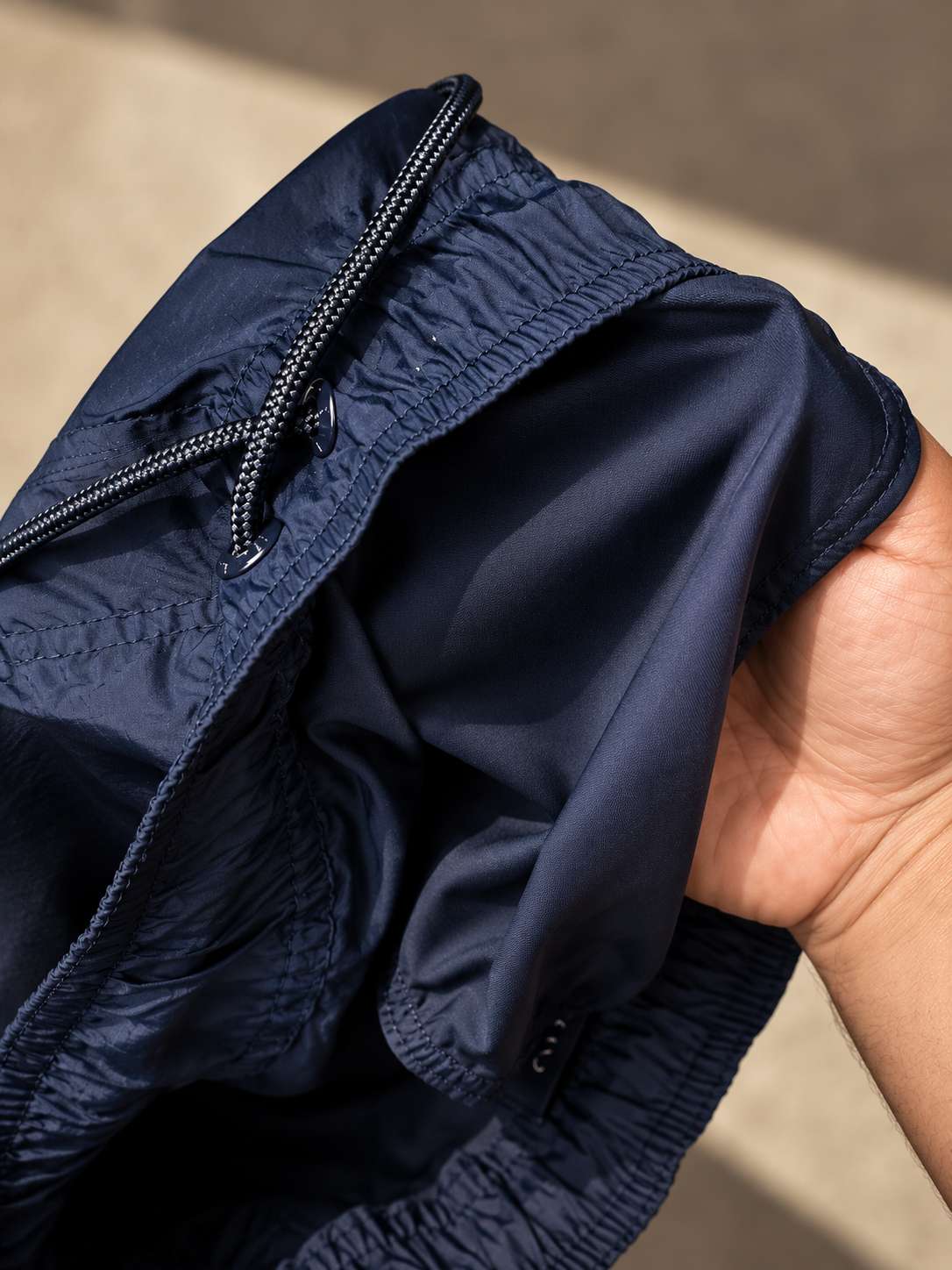 Detail of the MONTECITO navy blue swim shorts featuring a Japanese-made elastic waistband and Granite Island branded label.
