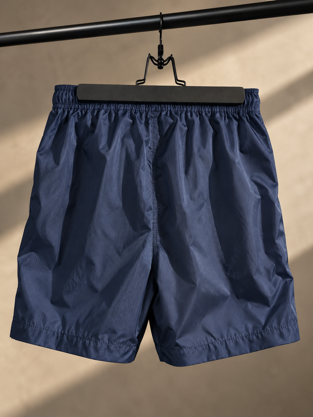 Back view of Granite Island MONTECITO navy blue swim shorts, showing the minimalist design, elastic waistband and Portuguese nylon fabric.