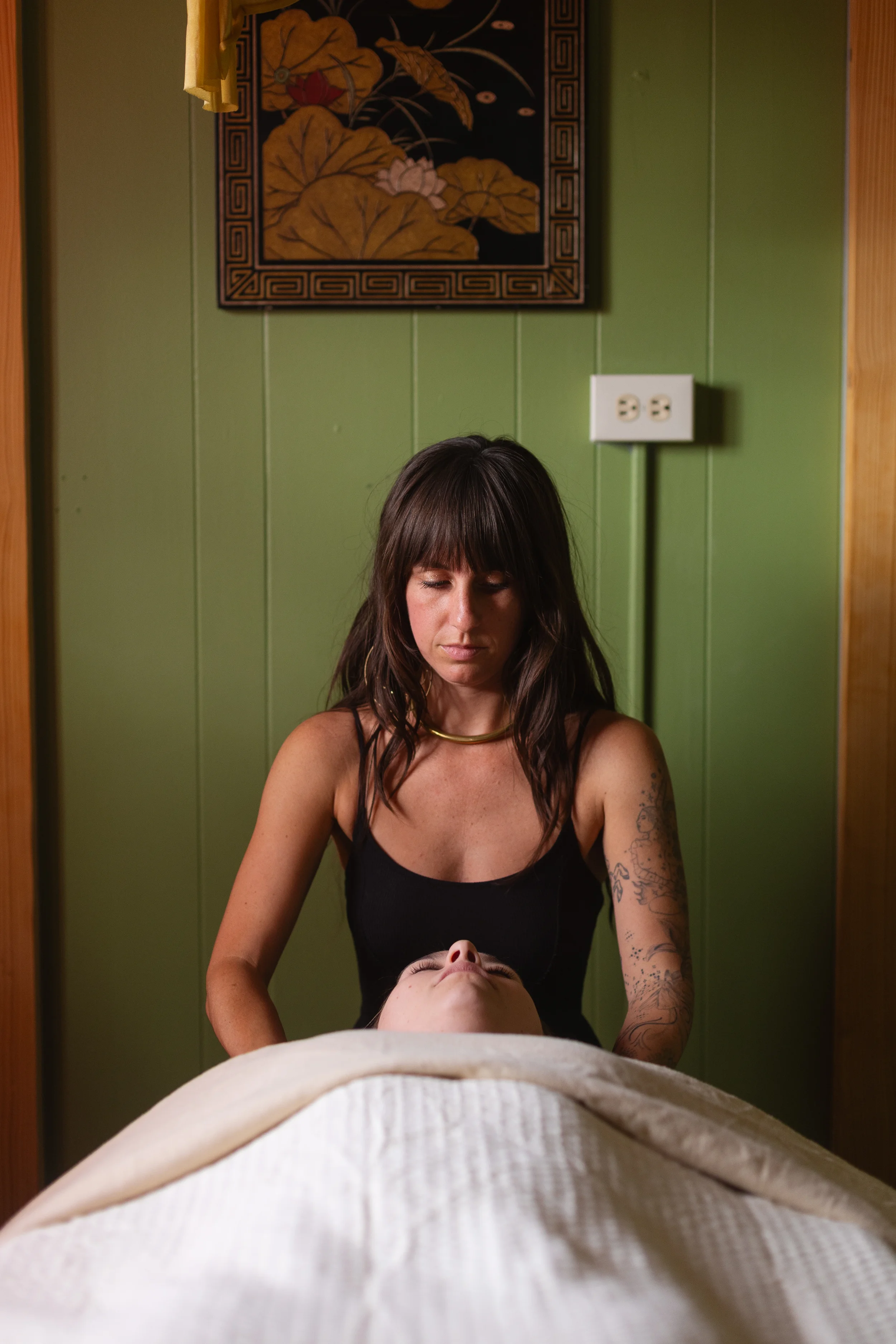 picture of Jenna massaging a clients shoulders at her studio in downtown Asheville