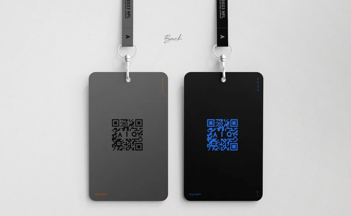 Two black and gray ID badges with QR codes hanging from straps on a white wall, with the word "Back" written above and small inscription reading "aiq.team" at the bottom of each badge.