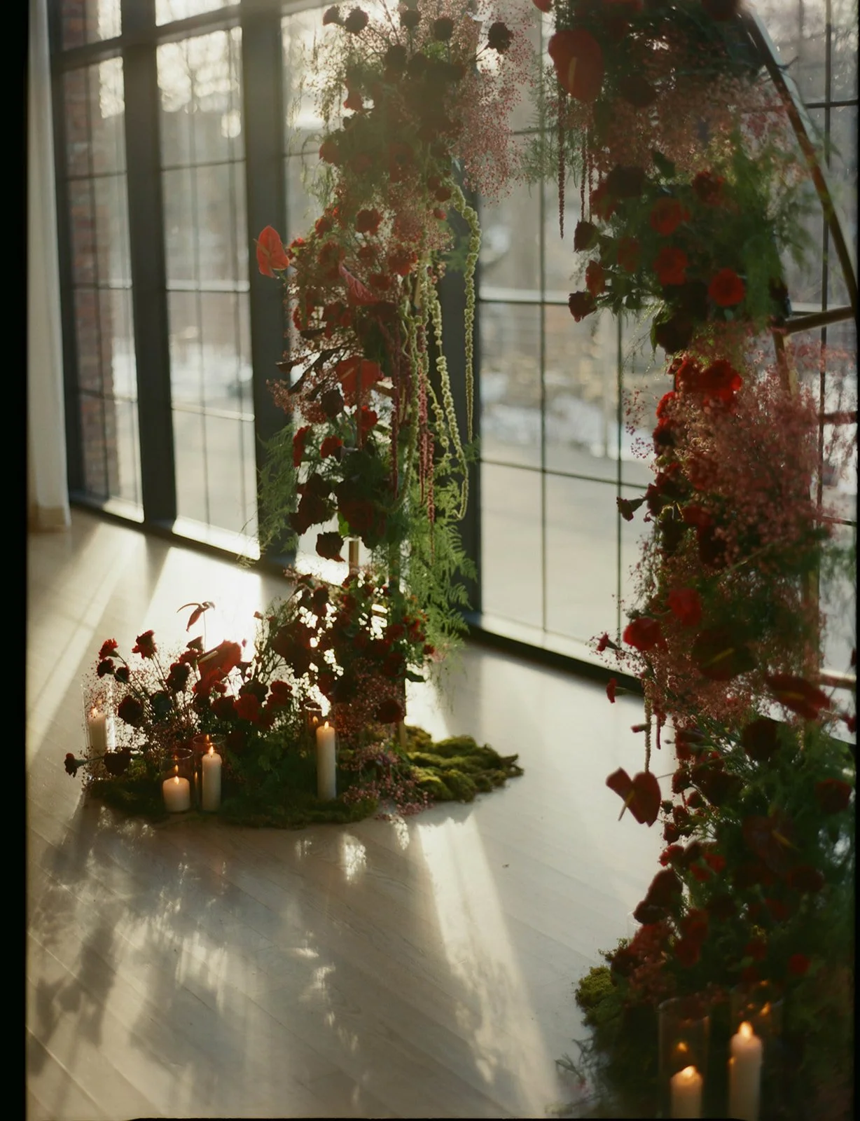 red floral arch and ceremony site