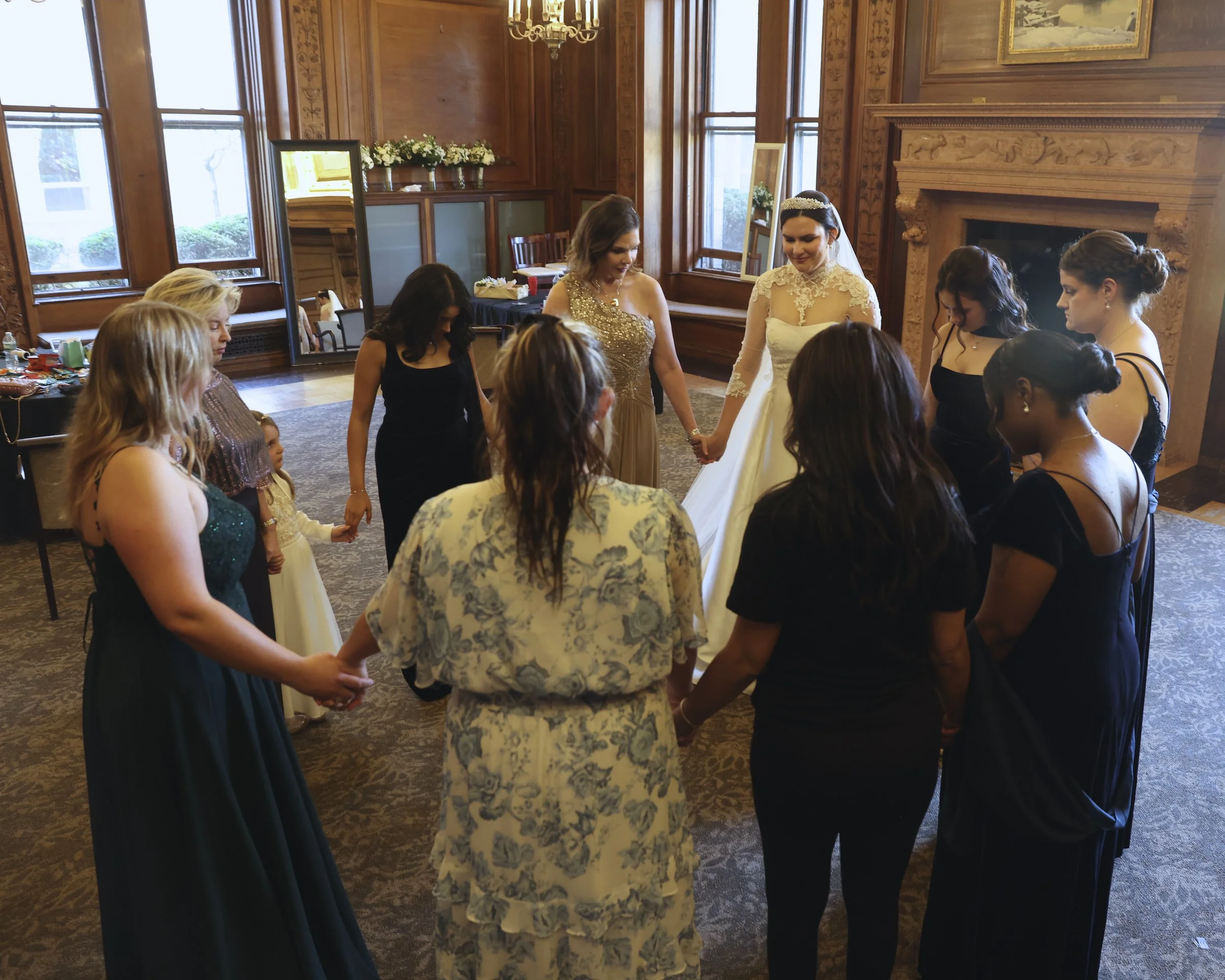 makeup artist praying with bride and family