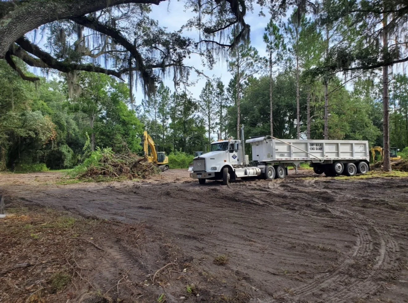 End-dump truck hauling debris on a Knepp Construction land clearing site