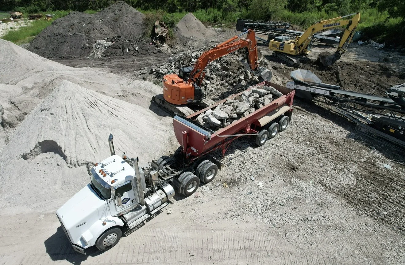 Aerial view of Knepp Construction dump truck being loaded with concrete debris for recycling