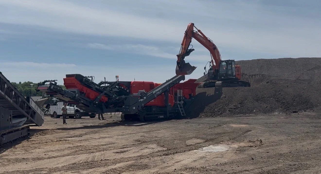 Hitachi excavator feeding a Finlay mobile crusher on a Knepp Construction job site