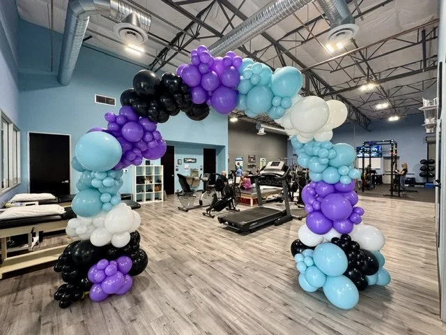 Balloon arch purple blue black white business balloon display 