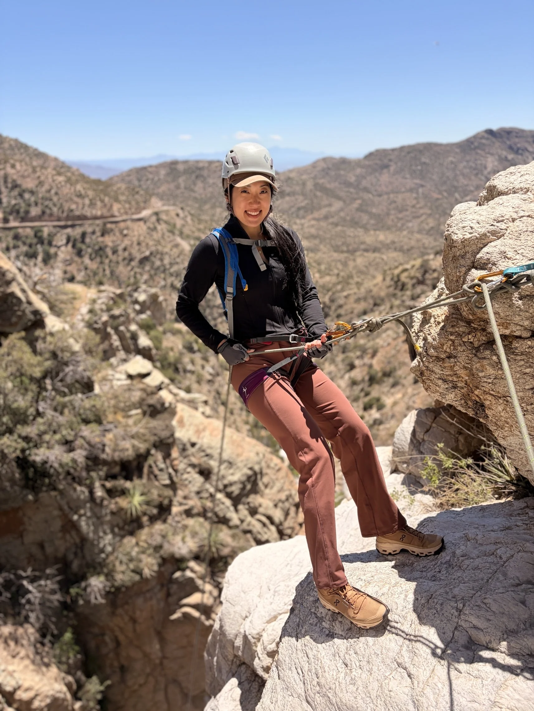 Canyoneer at a rappel anchor overlooking Seven Cataracts Canyon near Tucson