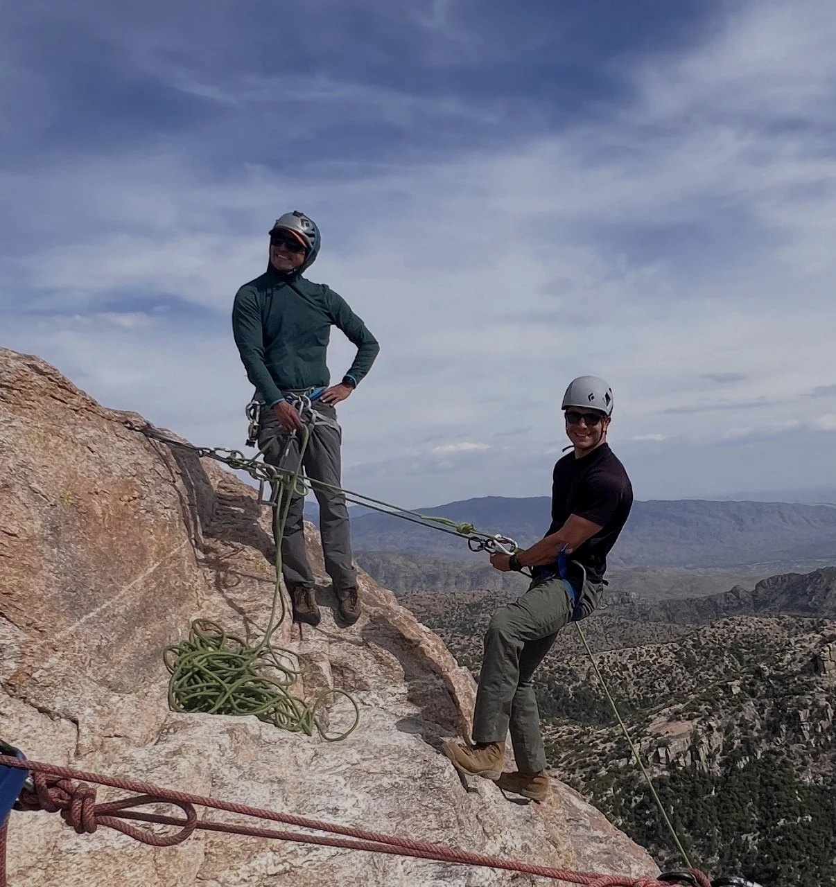 Two climbing guides managing ropes at an anchor on Mount Lemmon.