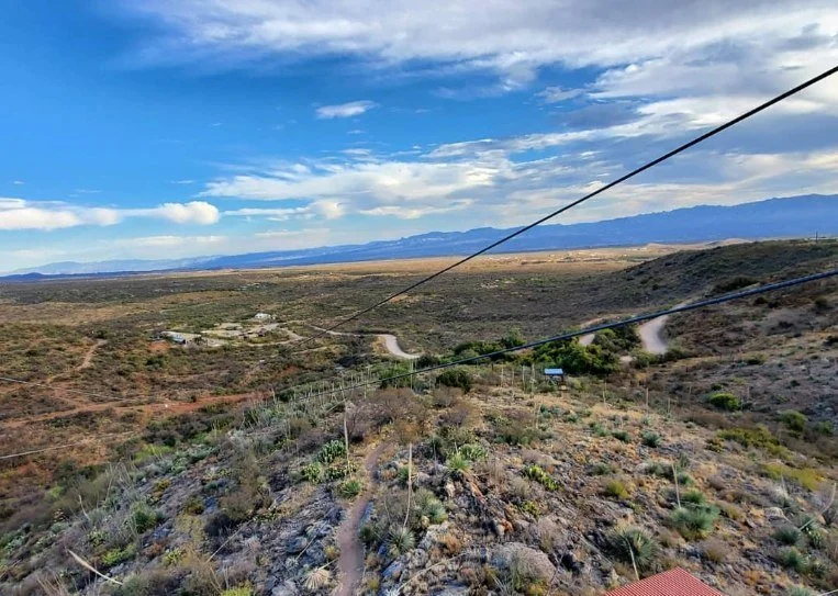 Zipline stretching over cactus-covered desert terrain near Tucson