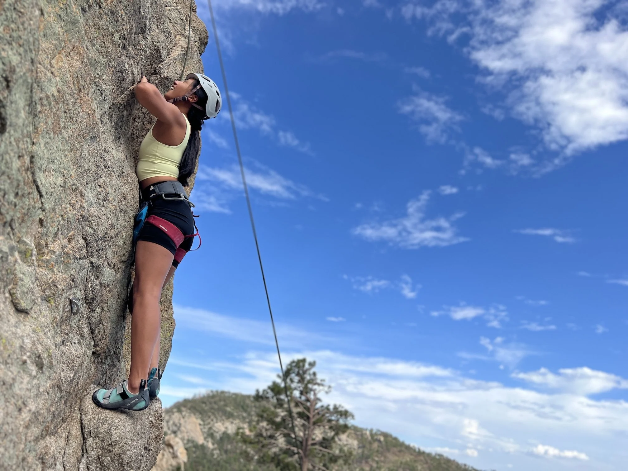 Woman rock climbing on granite at Mount Lemmon near Tucson.