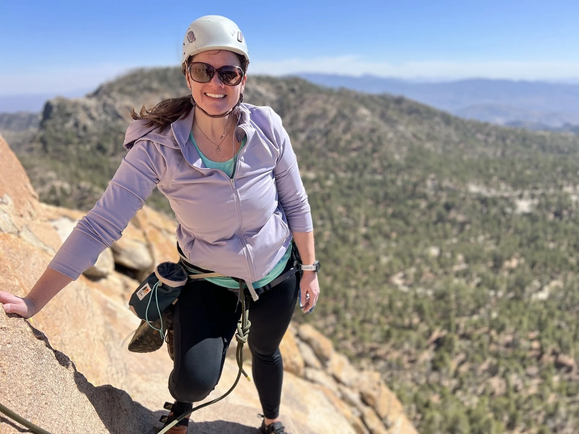 Guest smiling during a guided rock climbing trip on Mount Lemmon.
