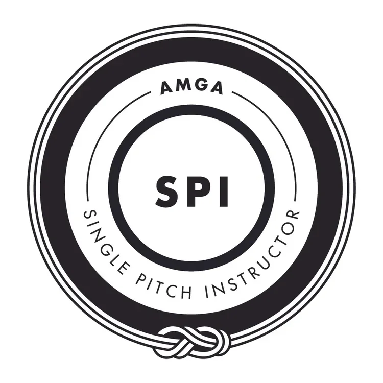 A circular emblem with black and white design, featuring the words "AMGA," "SINGLE PITCH INSTRUCTOR," and the initials "SPI" at the center.