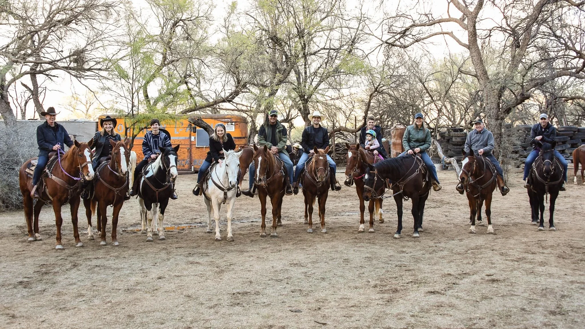 Family horseback riding through the Sonoran Desert near Tucson