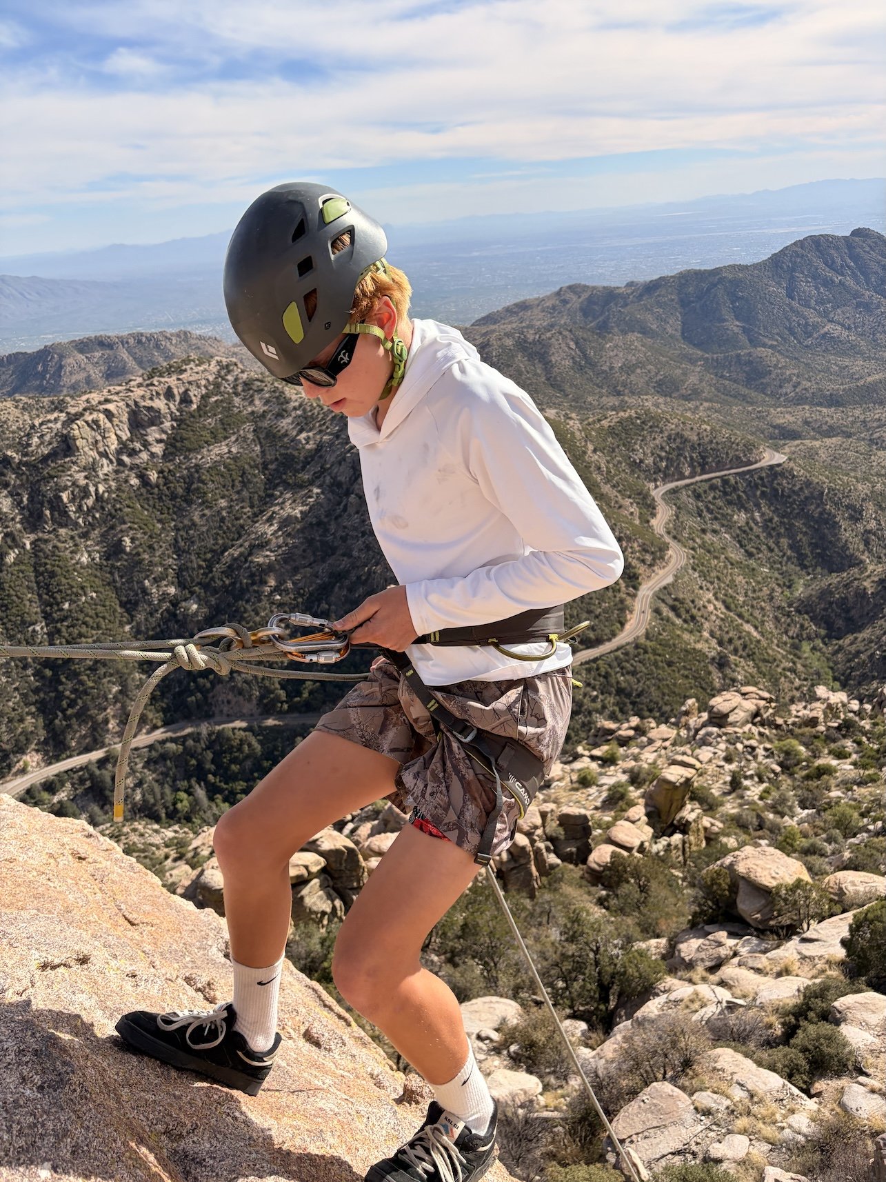 Young rappeller descending a granite cliff on Mount Lemmon