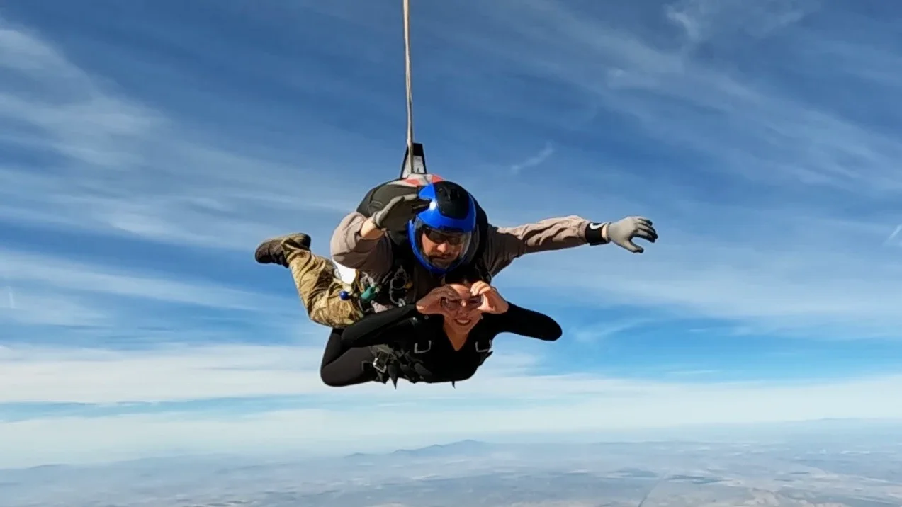 Tandem skydiving instructor and guest in freefall over Arizona