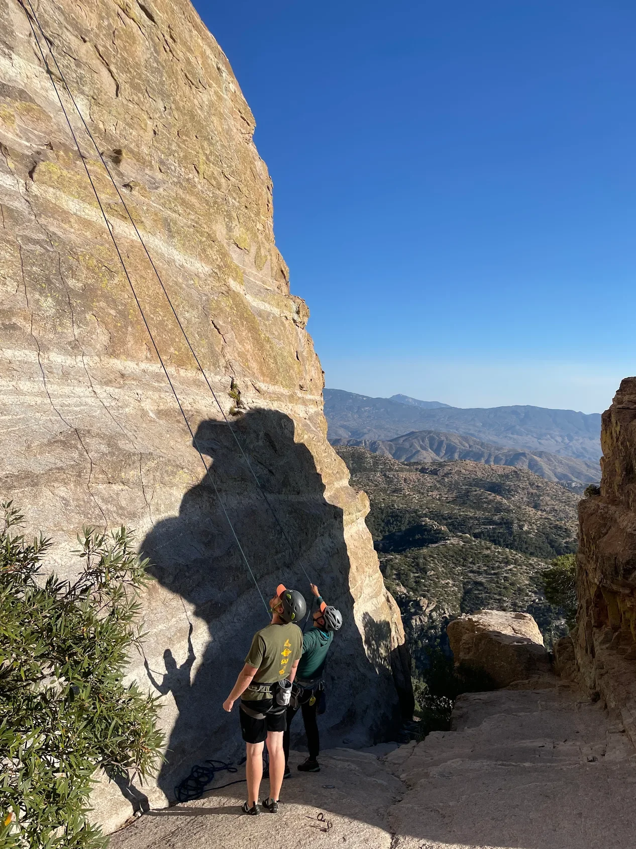 Two climbers at the base of a Mount Lemmon rock wall.