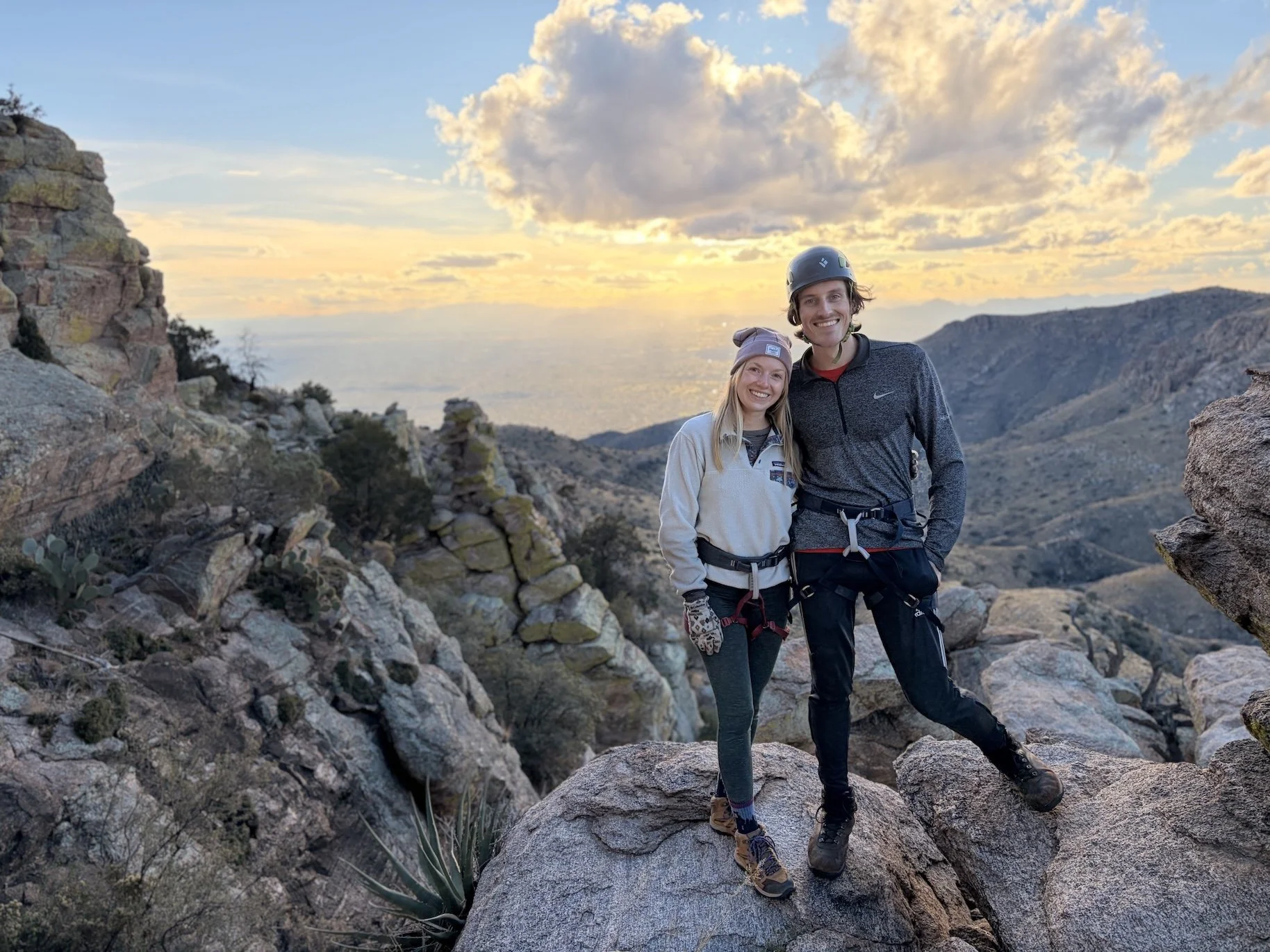 Couple in climbing harnesses at sunset on Mount Lemmon.