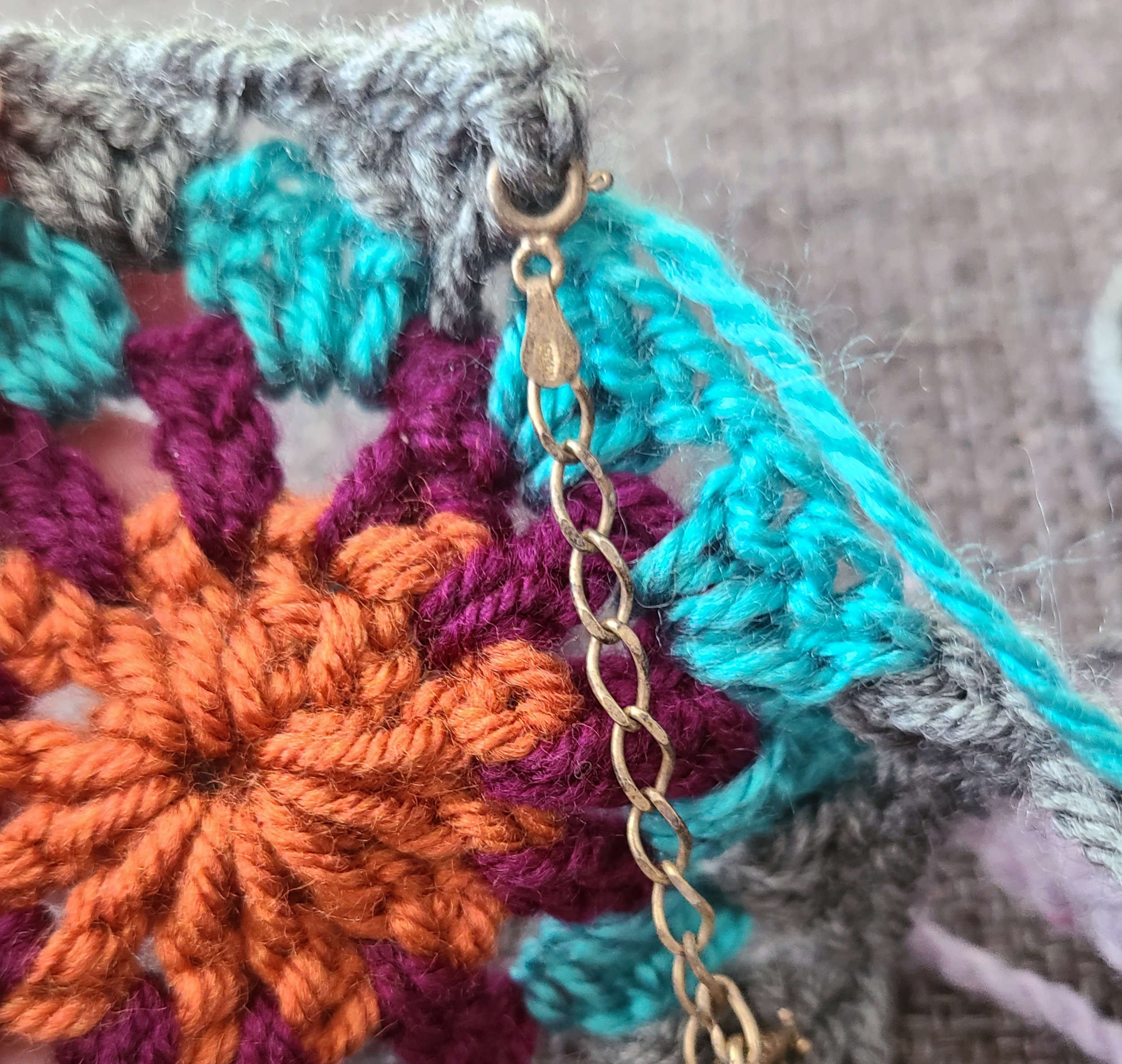 Photo of a jewelry chain with a c-clasp closure attached through a crochet stitch.