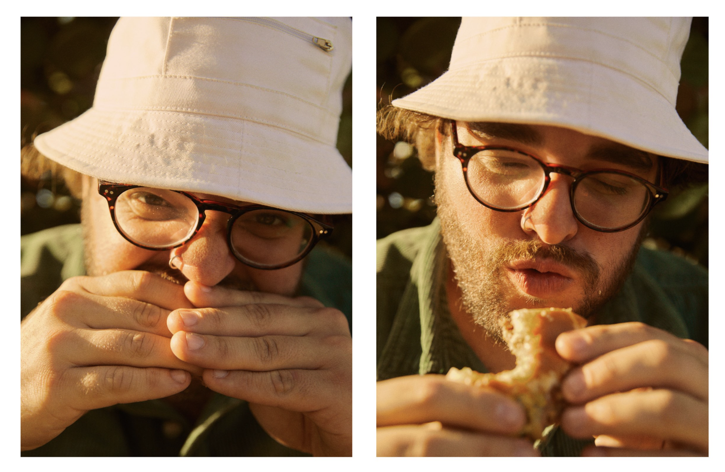A man wearing a white bucket hat, glasses, and a green shirt, eating a slice of pizza outdoors during golden hour sunlight.