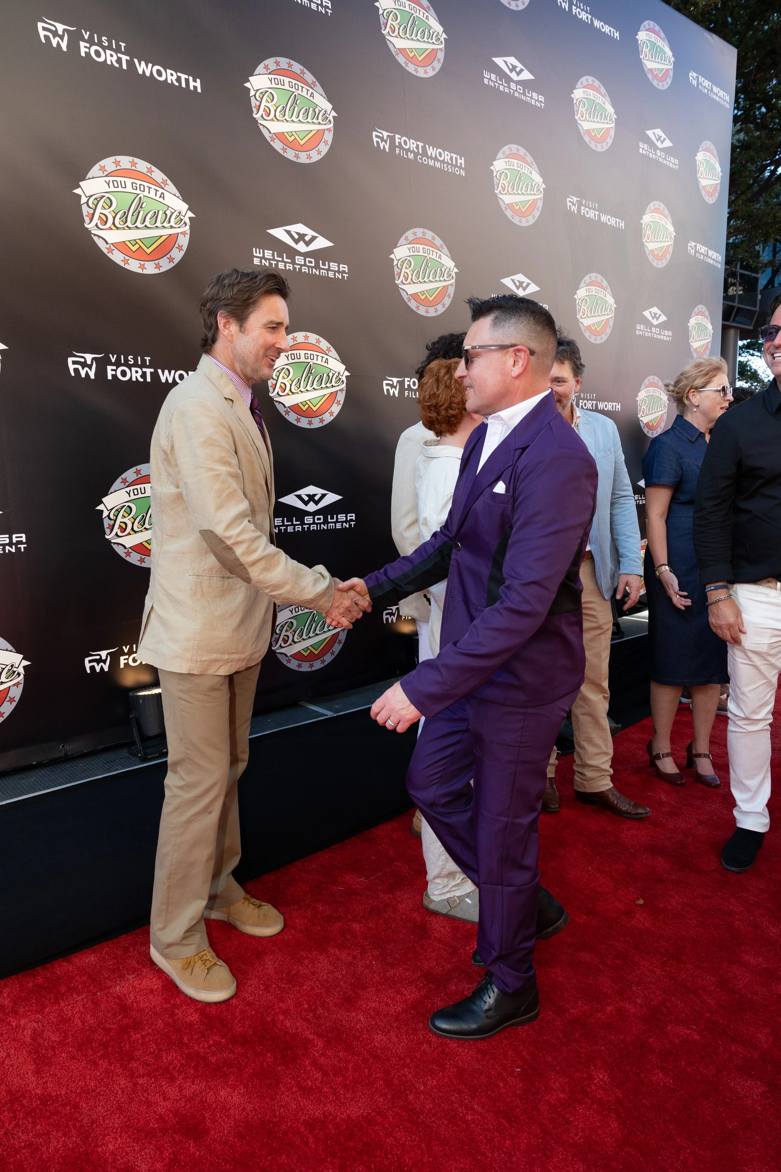 Luke Wilson shakes hands with film writer at a custom red carpet premiere wiht event planning done by Copper Light Events