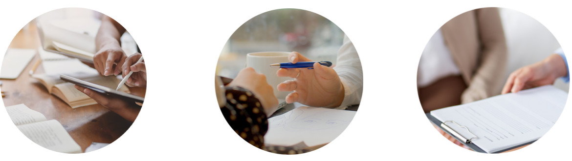 Close-up of multiple people reviewing documents and taking notes during a business meeting.