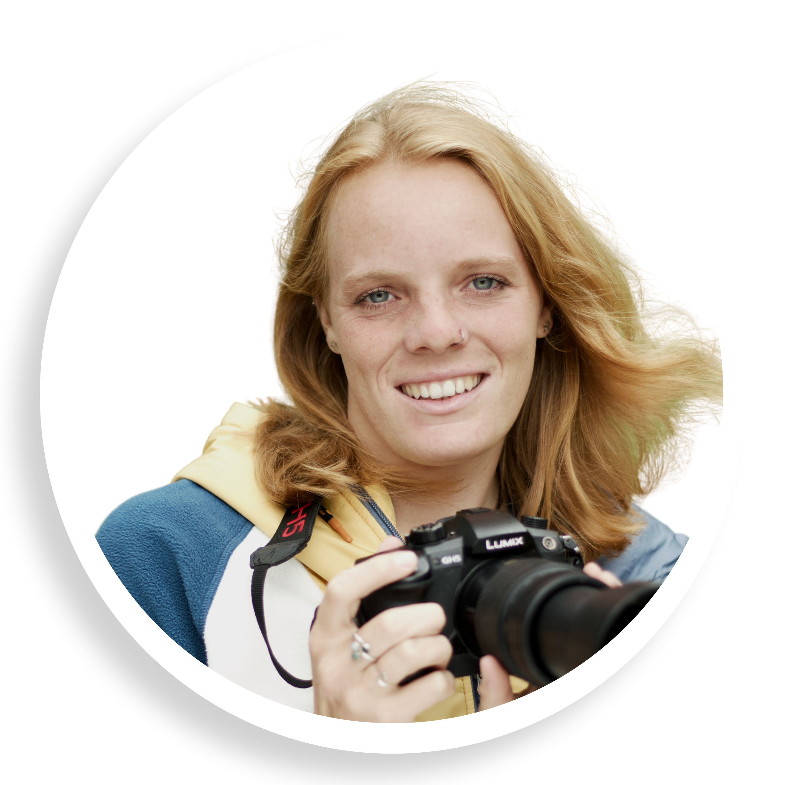 Image of Becky Peet holding camera and smiling