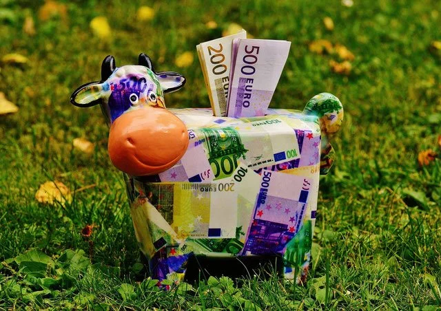 tirelire vache colorée dans herbe économie
