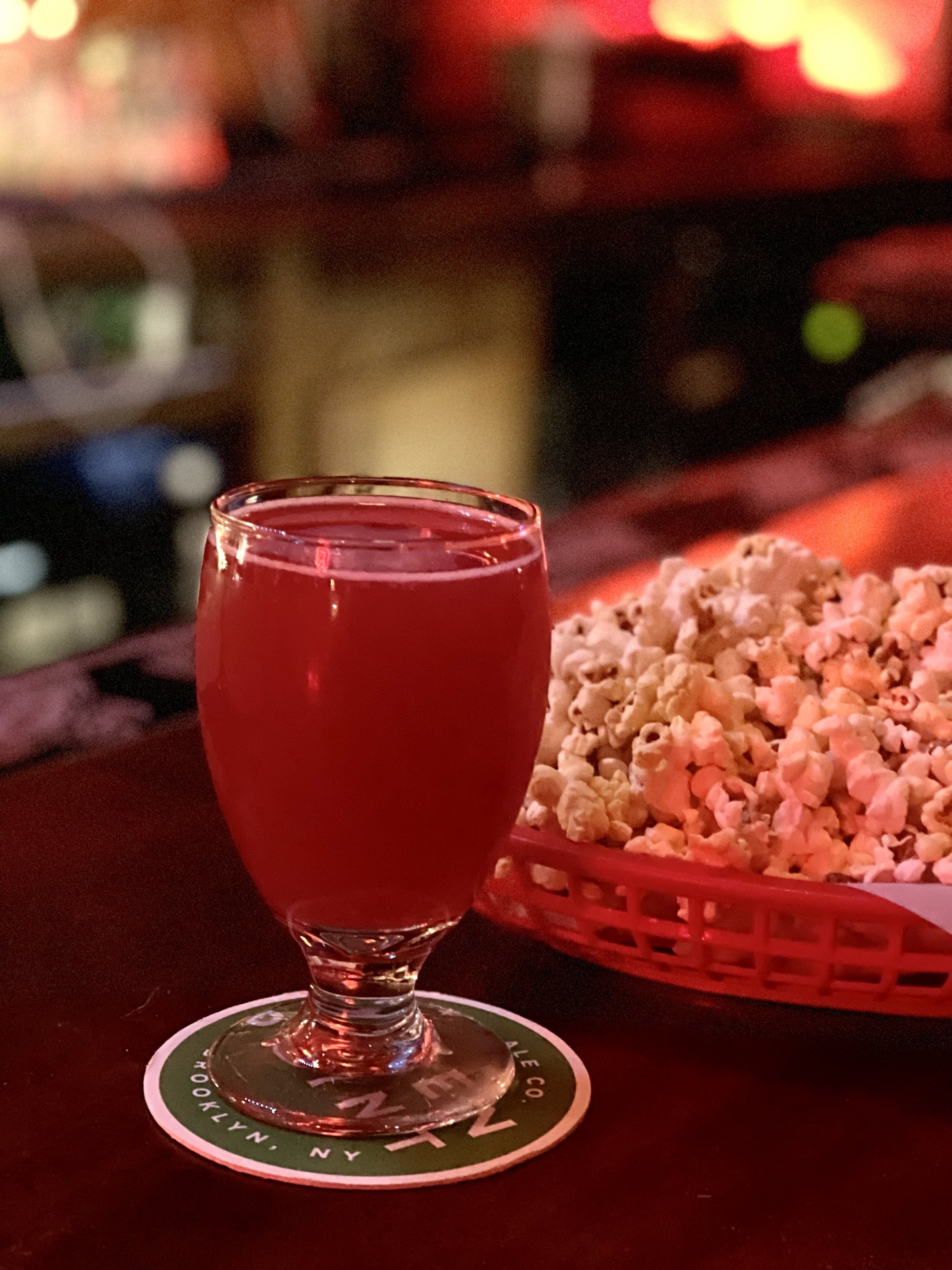beer_red sour beer in a glass at a bar with popcorn IMG_2028.jpeg