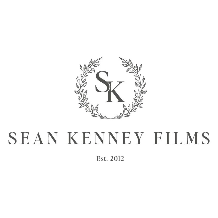 Logo design for wedding videographer, Sean Kenney Films featuring initials SK in a laurel wreath with the text 'SEAN KENNEY FILMS' and 'Est. 2012'.