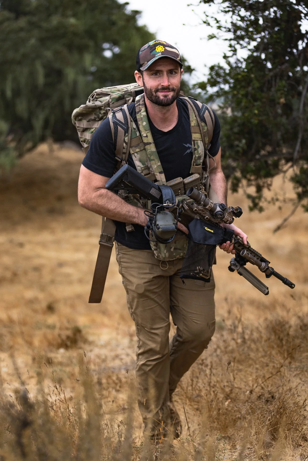 Image of man with gun and backpack