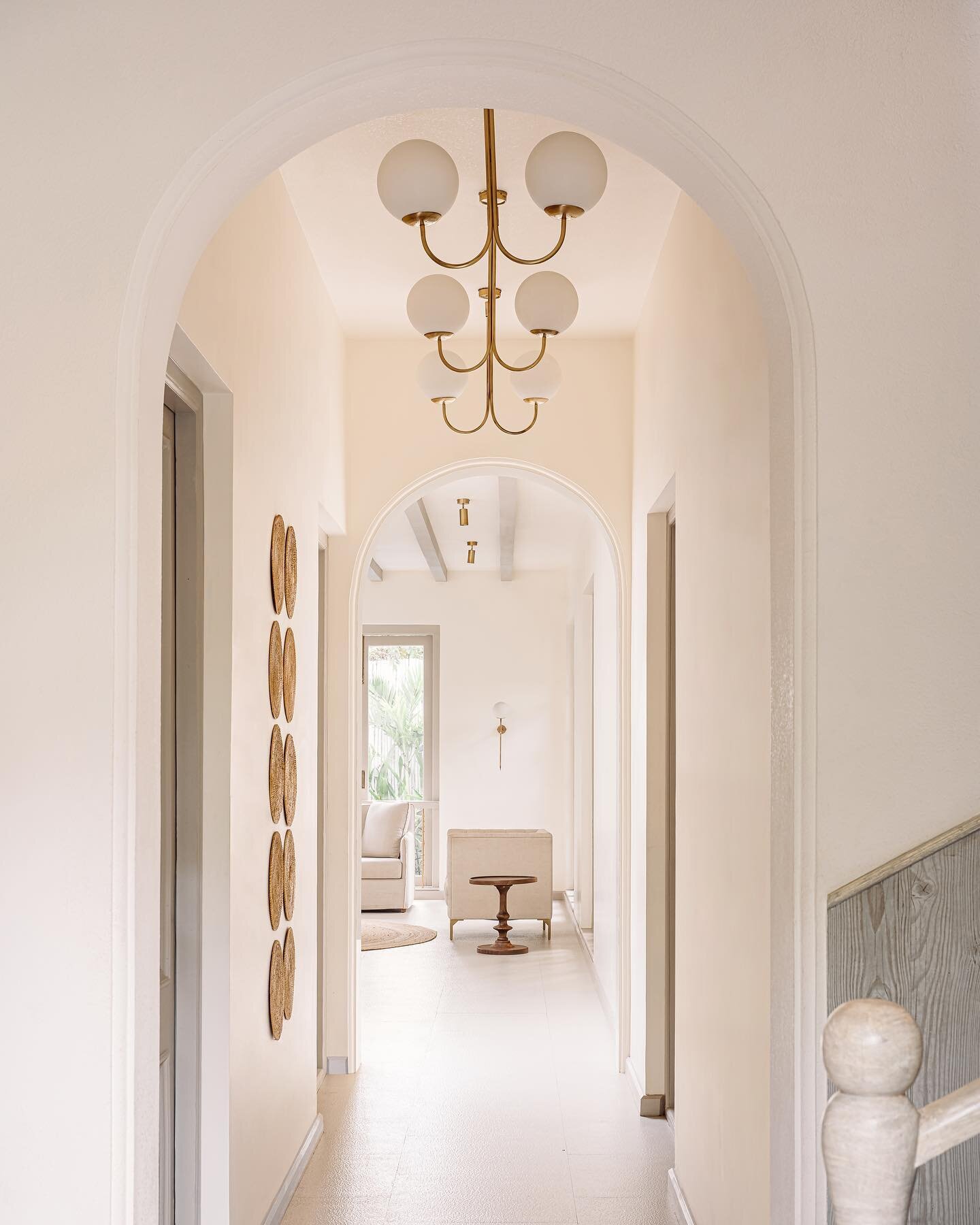 Featuring a harmonious ensemble of arched forms, cane installations, and globed chandeliers in this beautiful passageway of Castello Vaddo 3.

Developer: @isprava 
Photography: @ishifishy 

#aashnikumar #luxuryresidences #residentialdesign #interiord