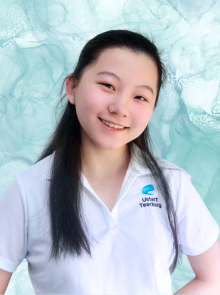 Young girl with long dark hair smiling, wearing a white shirt with a logo that says 'Ustart Teaching', in front of a light blue abstract background.