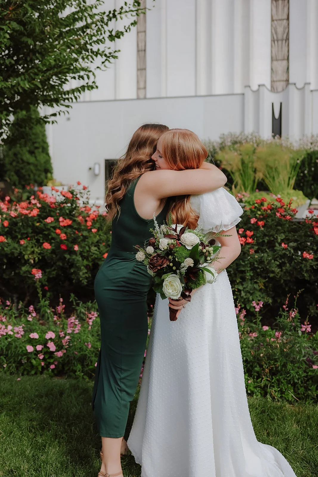 Bride with bridesmaid in green dress at the jordan river temple