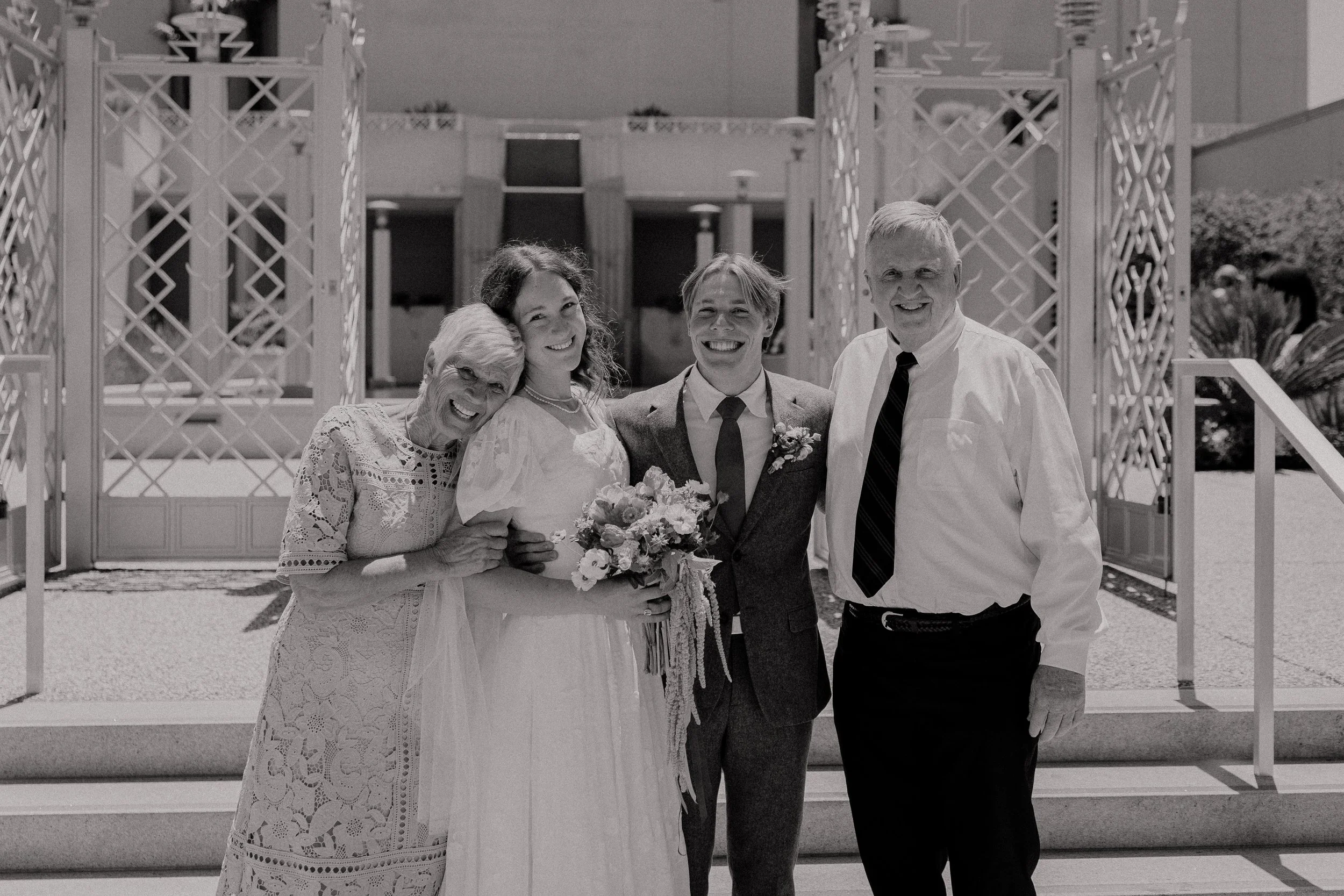 California Oakland temple LDS wedding photographer bride and groom bright florals red color theme Santa Rosa backyard wedding reception black and white family photo with grandparents