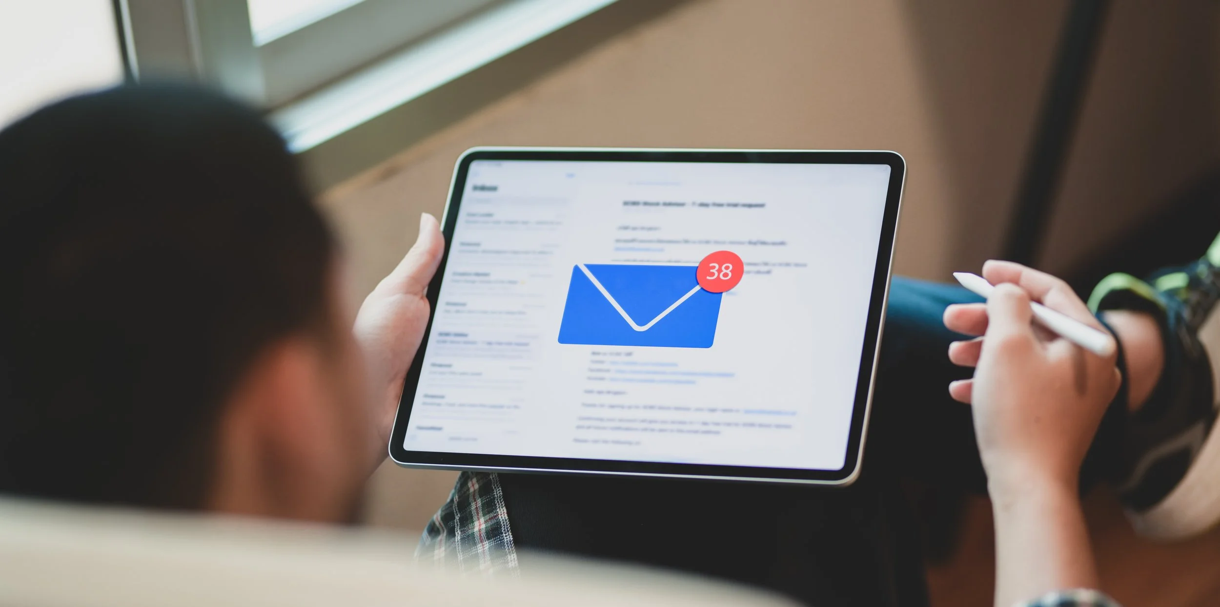 young-businessman-checking-his-email-tablet.jpg