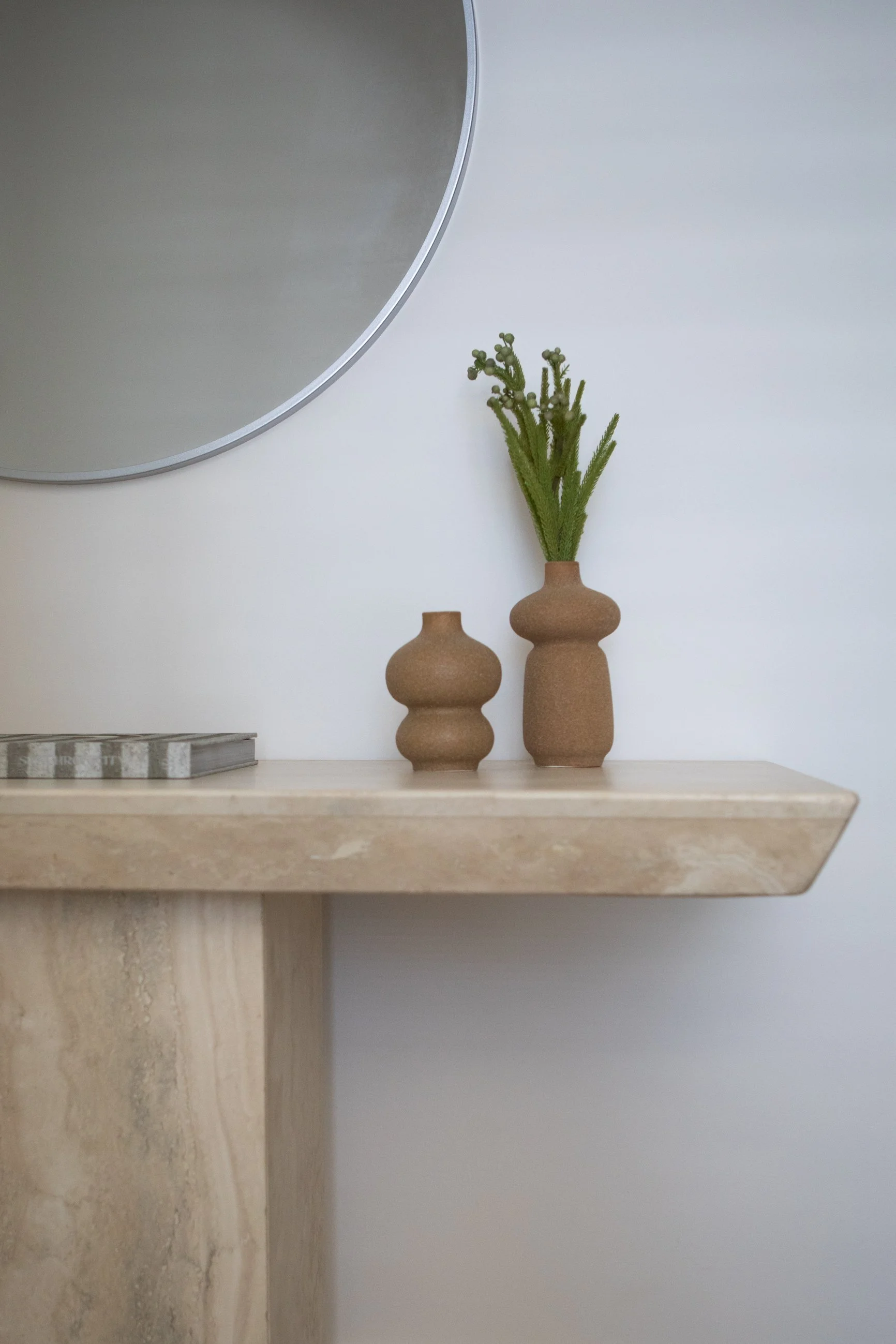 Neutral console styling with ceramics and natural timber tones